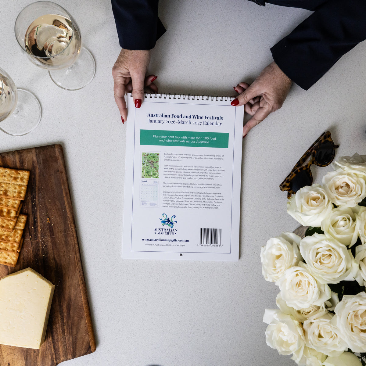 HANDS HOLDING BACK COVER OF AUSTRALIAN FOOD AND WINE FESTIVALS CALENDAR